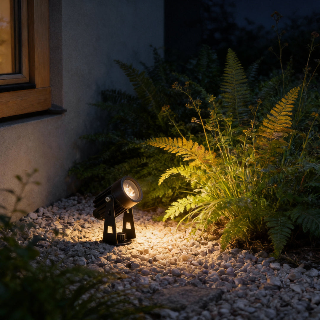Garden solar powered landscape spotlights illuminating a garden pathway at night