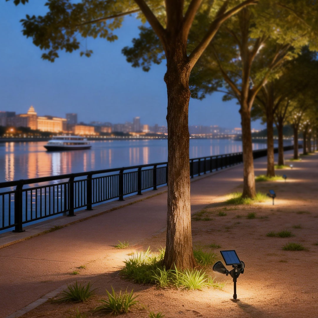 Garden spotlights solar powered illuminating a riverside pathway with warm, directional glow.
