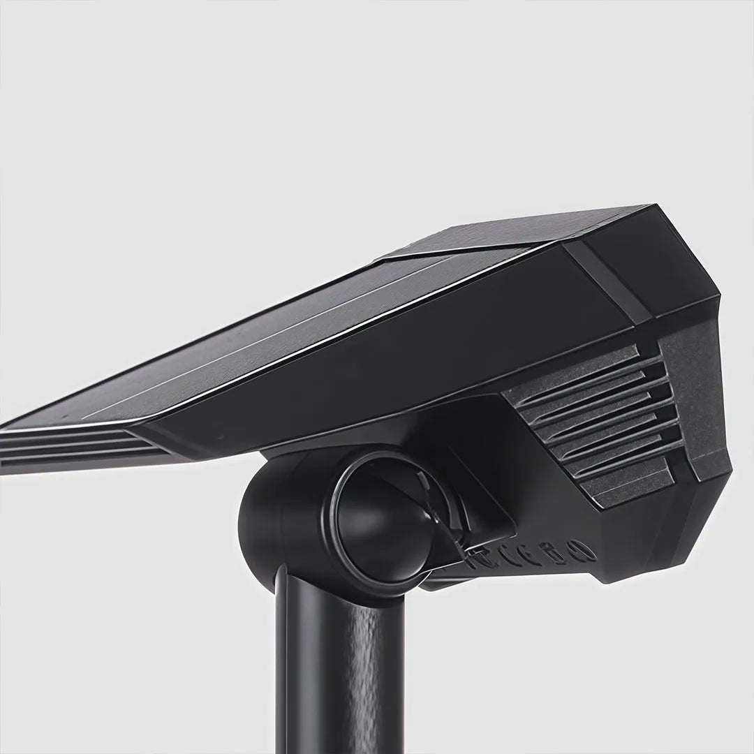 Close-up of garden stake solar lights showing the adjustable head, solar panel, and black housing.