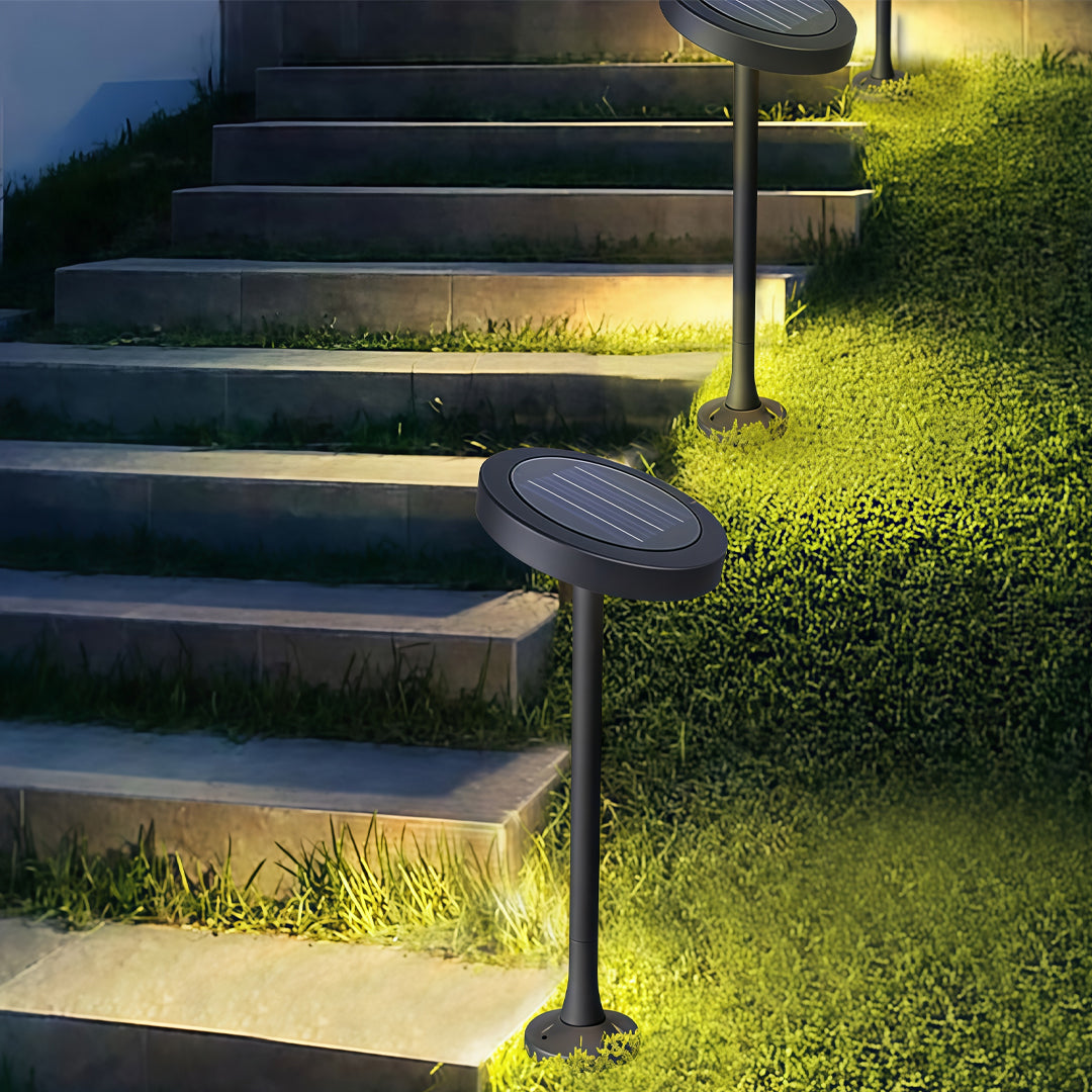 Modern path lights outdoor installed along garden steps, creating warm ambient illumination.