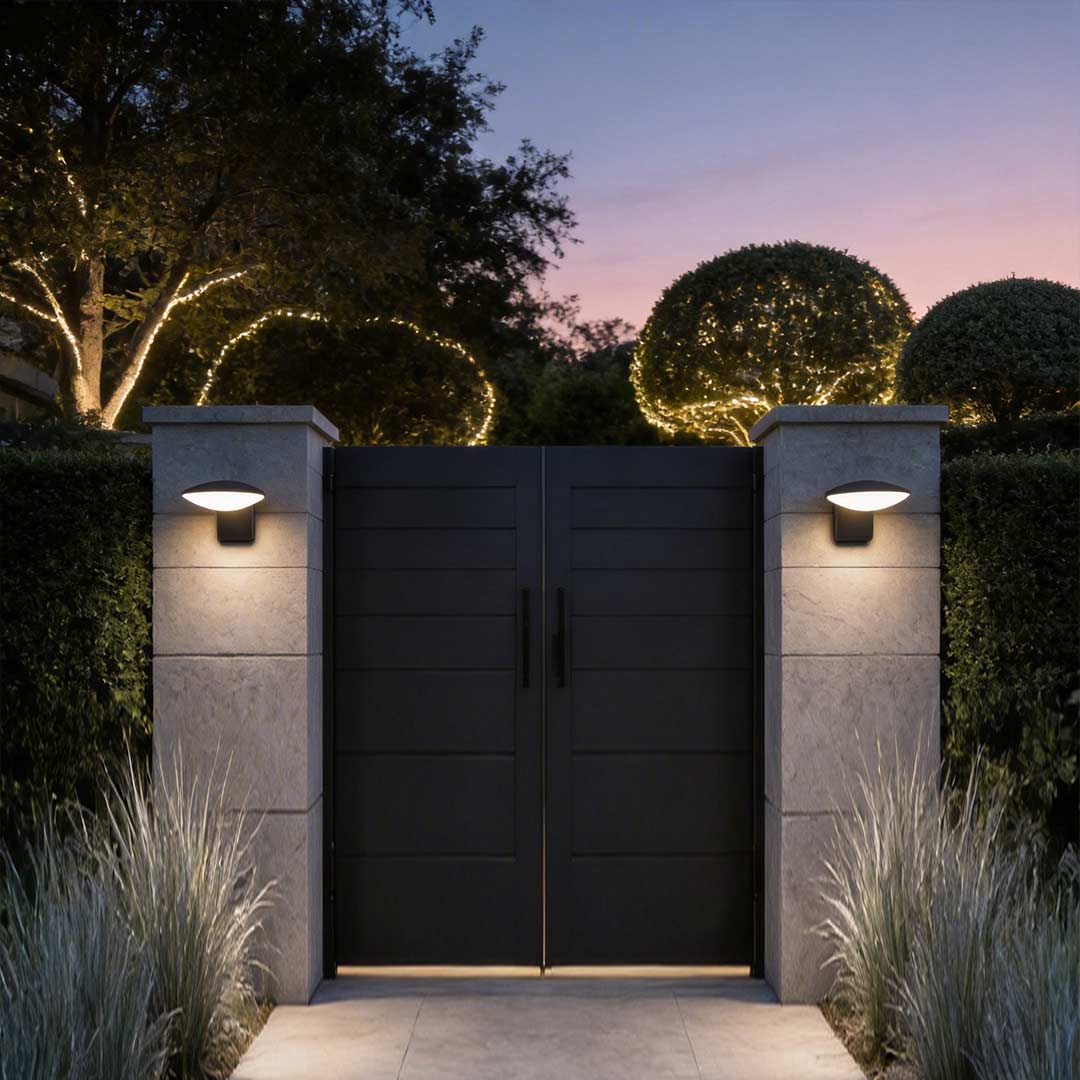 Garden wall lights illuminating a modern house entrance with warm directional glow.