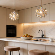 Gardenia pendant light illuminating a modern kitchen island with warm ambient glow.