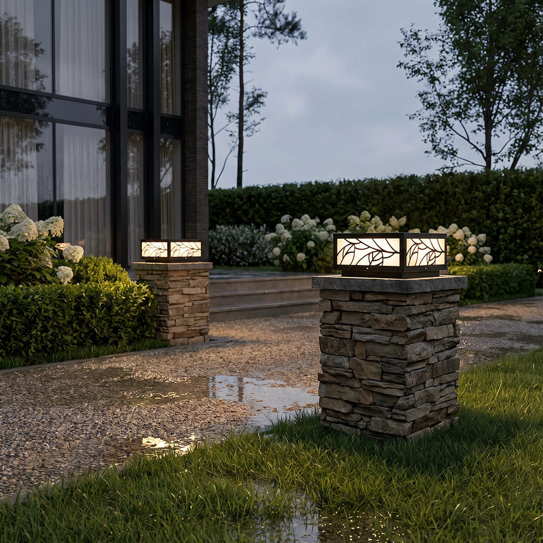 Gate pillar light mounted on a stone column beside a garden path and modern exterior.