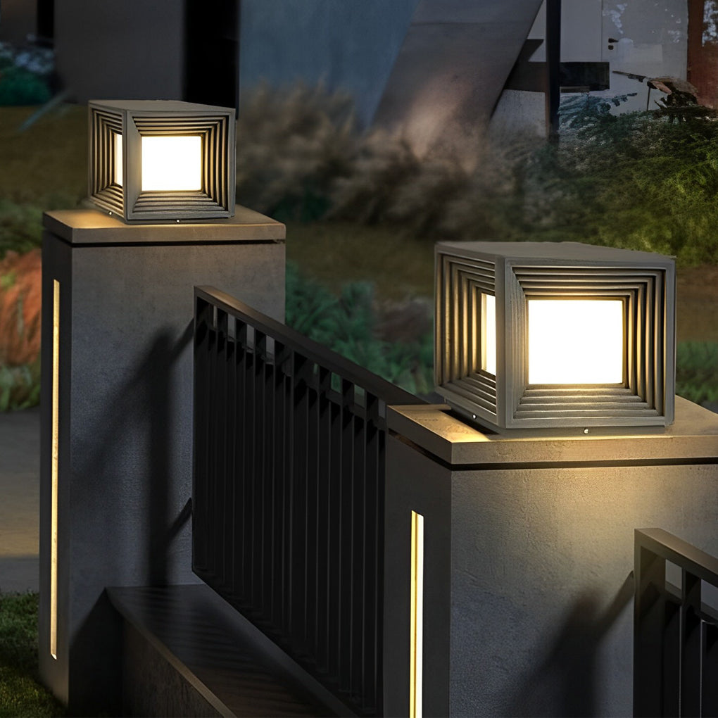 Gate pillar lights with a geometric design, mounted on a stone pillar.