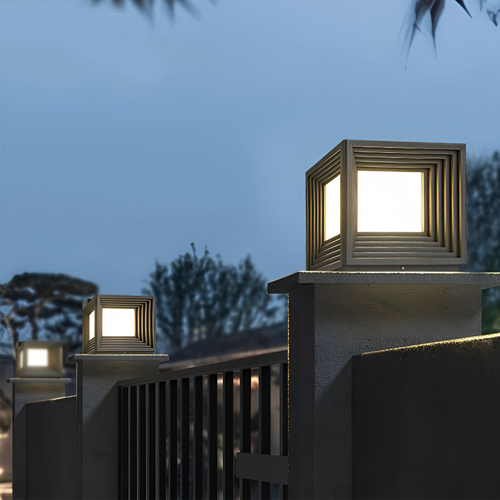 Square gate pillar lights illuminating a modern outdoor staircase at night.