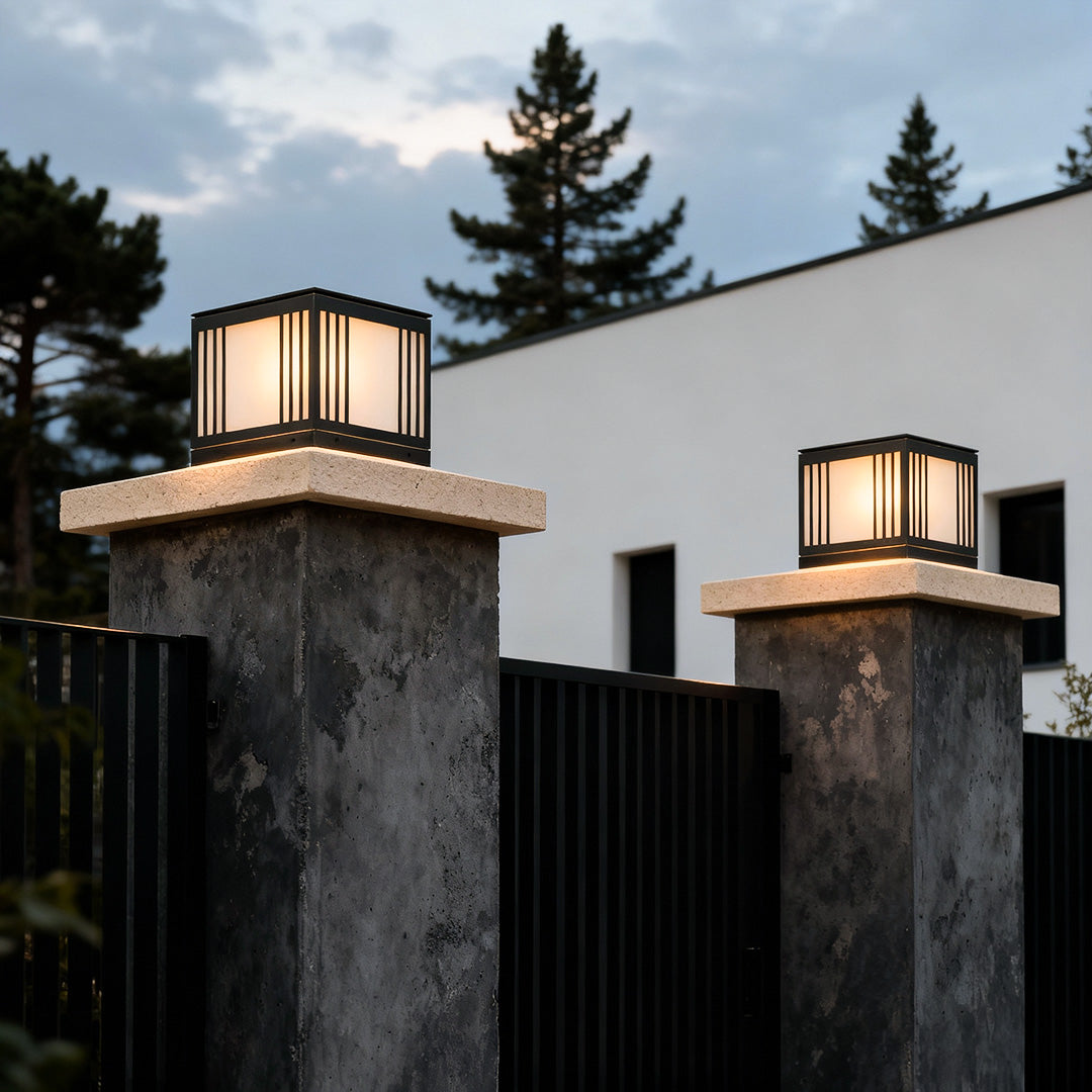 Gate pillar solar light mounted on a stone pillar, providing soft illumination for a driveway.