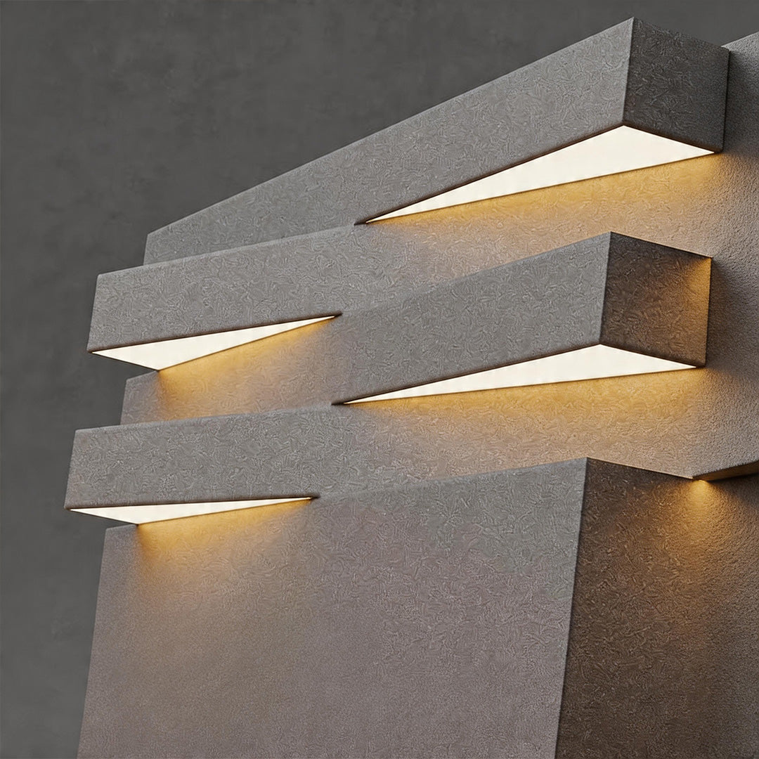 Gate post solar pillar light close-up featuring geometric layered diffuser with integrated LED lighting.