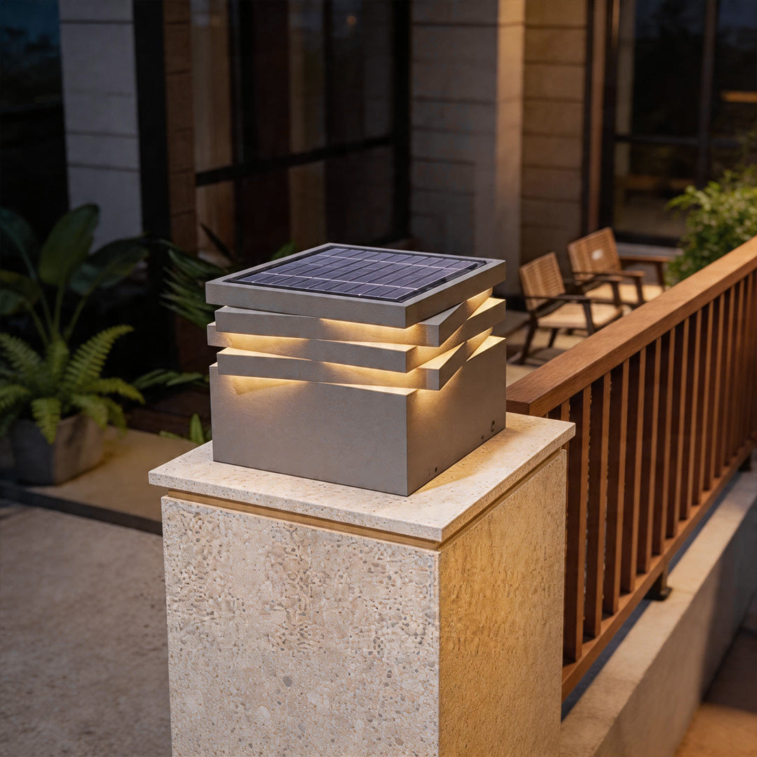 Gate post solar pillar light installed on patio stone column with warm modern outdoor illumination.