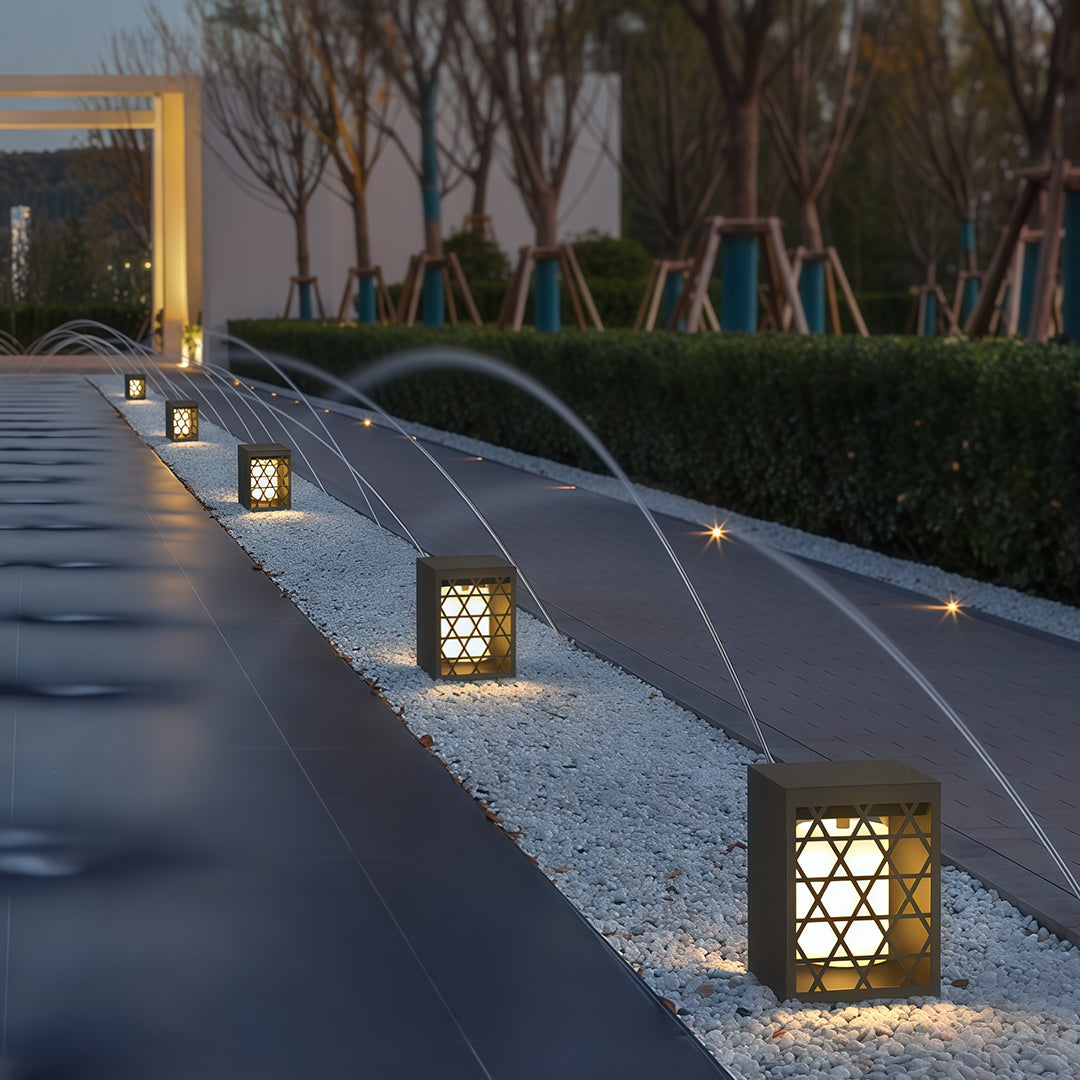 Sleek bollard lighting with geometric patterns, ideal for brightening up outdoor patio and garden areas.