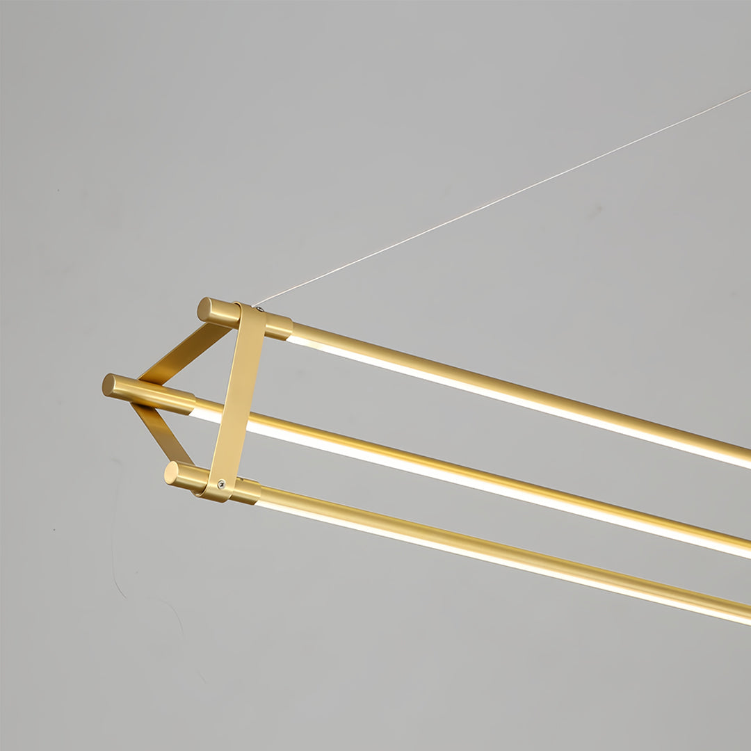 Designer linear pendant lights with brass tubing creating geometric lighting pattern in modern office
