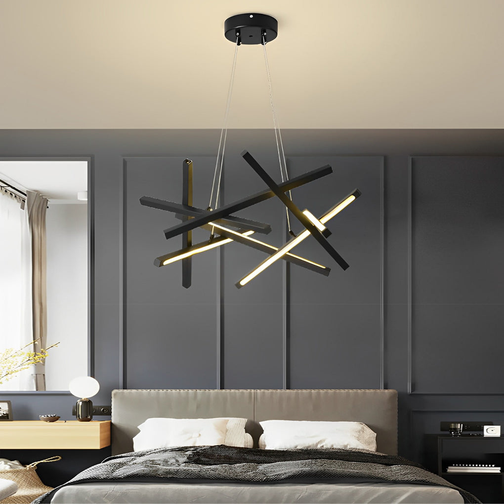 Geometric ceiling light with black linear LED rods mounted above a bed, creating a striking contrast in a modern dark-toned bedroom.