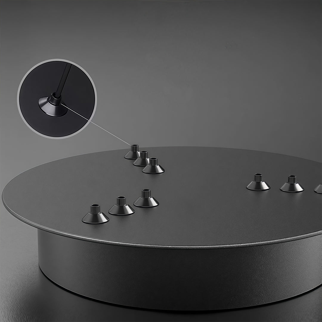 Ceiling mount canopy and suspension hardware for a geometric ceiling light, highlighting adjustable cables and modern installation design.