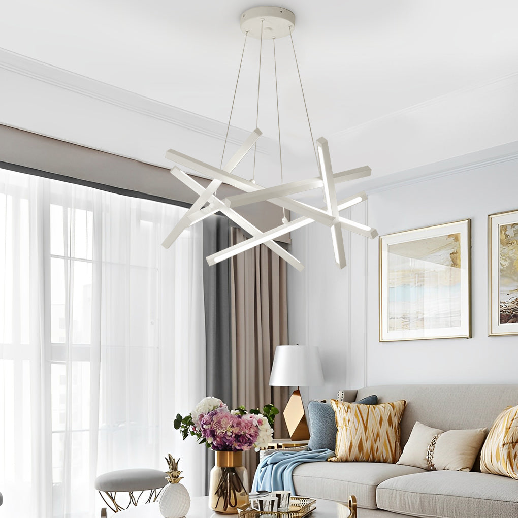 Minimalist geometric ceiling light in white finish, composed of crisscross LED bars, illuminating a modern living room with soft light.