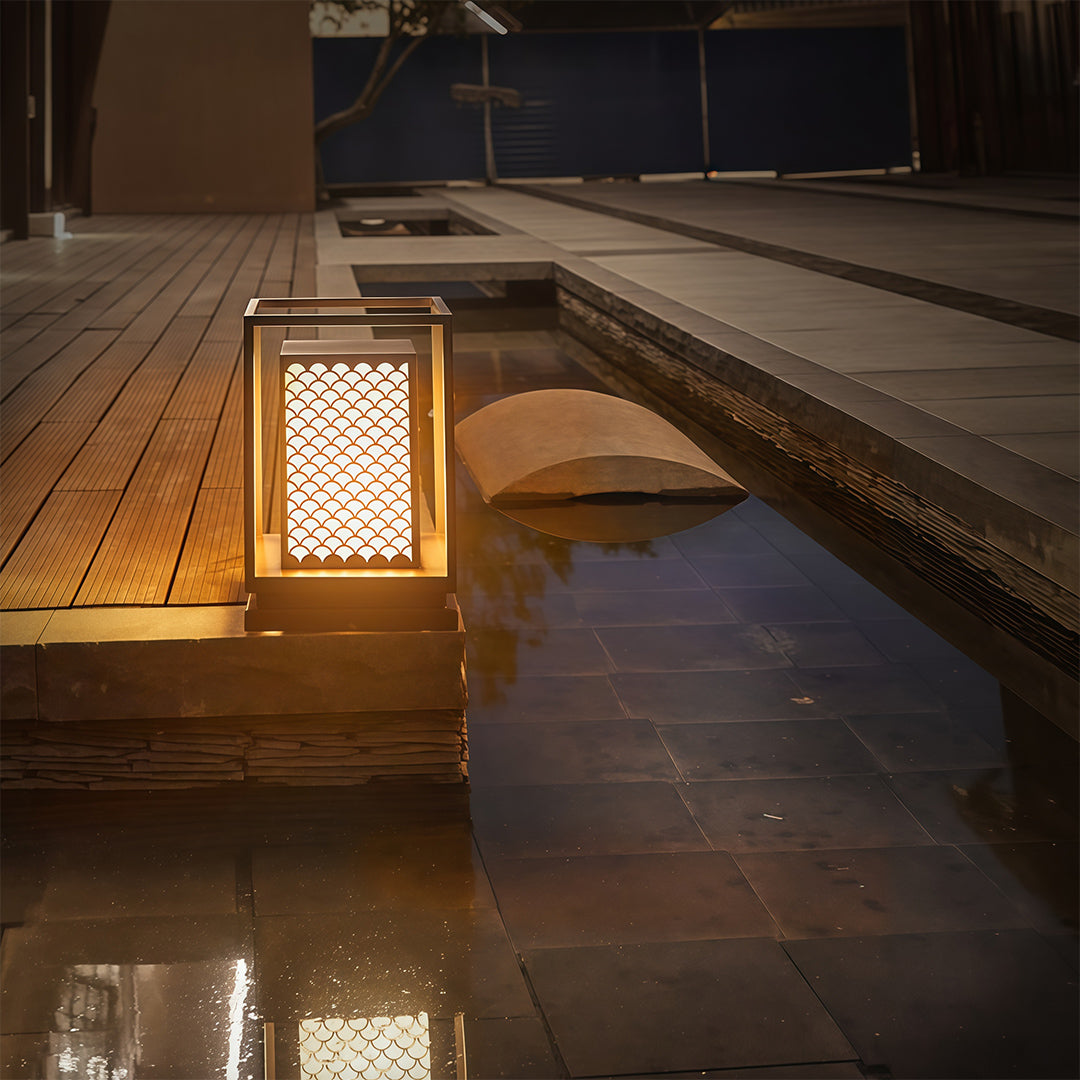 Bollard light with geometric design providing stylish illumination for outdoor settings like patios or walkways.