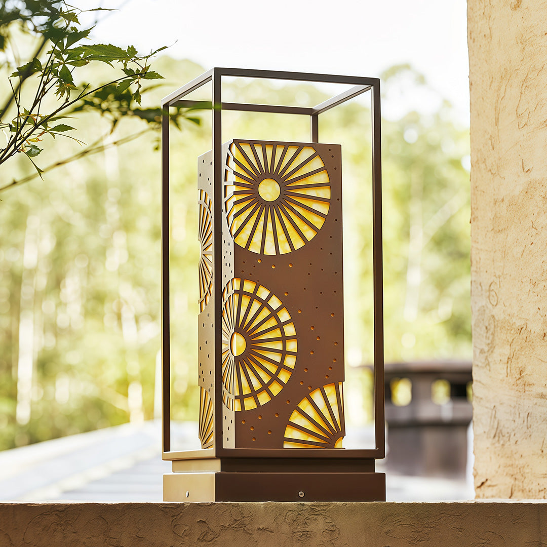 LED bollard light in an outdoor setting, illuminating a garden with a stylish geometric design.