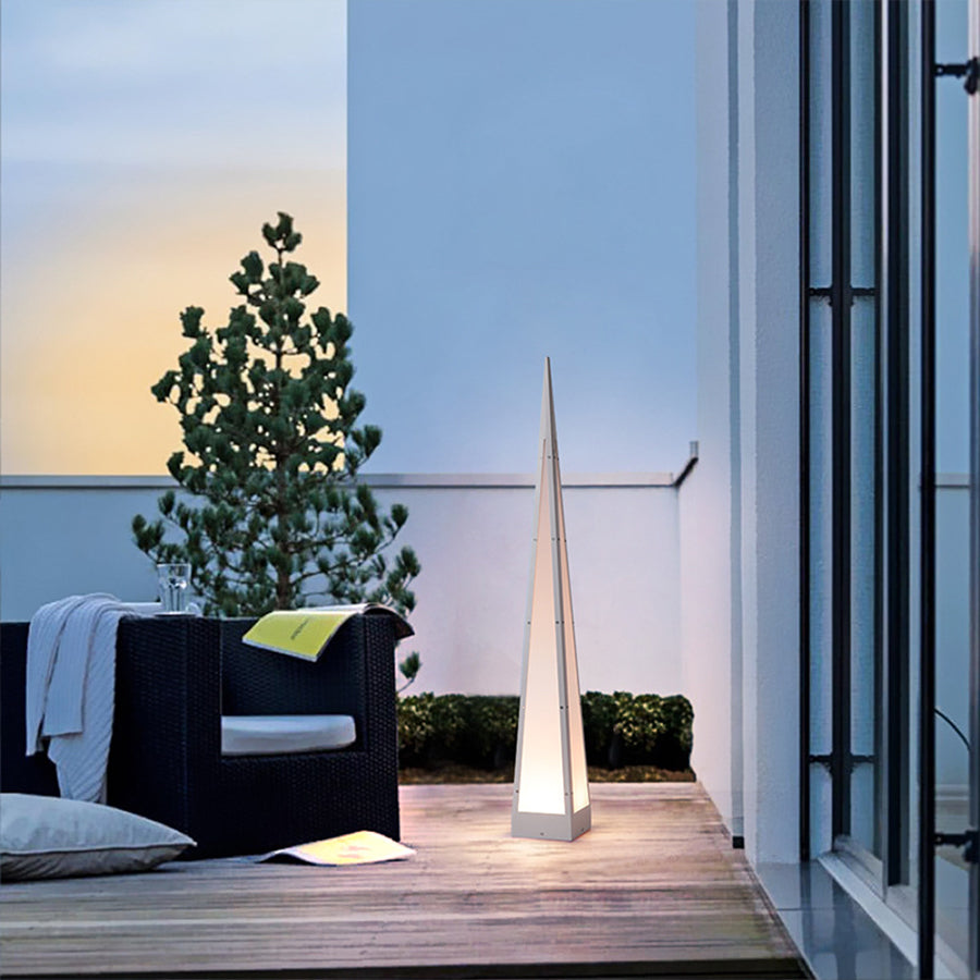 Modern geometric floor lights illuminating contemporary outdoor dining area