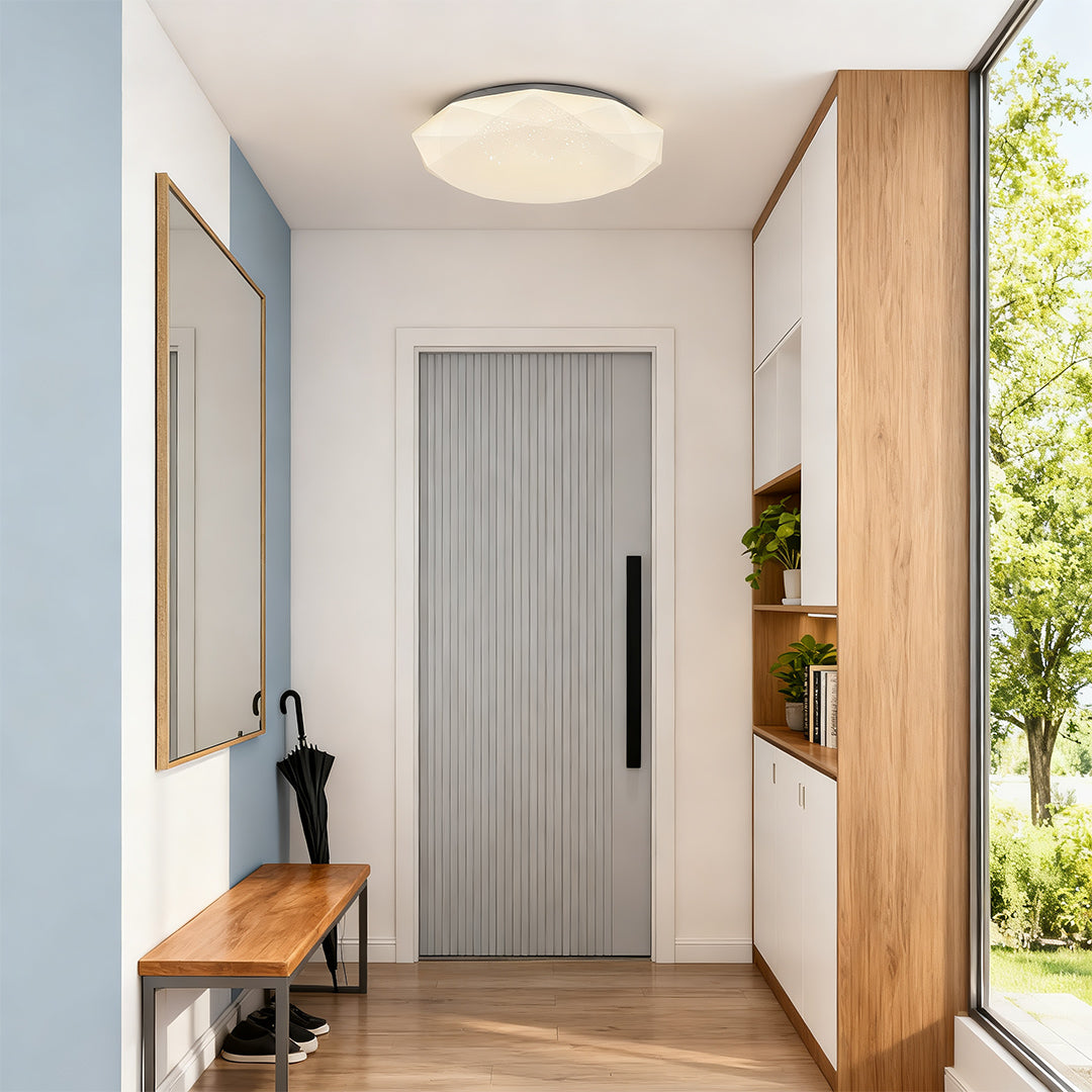Geometric flush mount ceiling light illuminating a modern hallway with wood and white décor.
