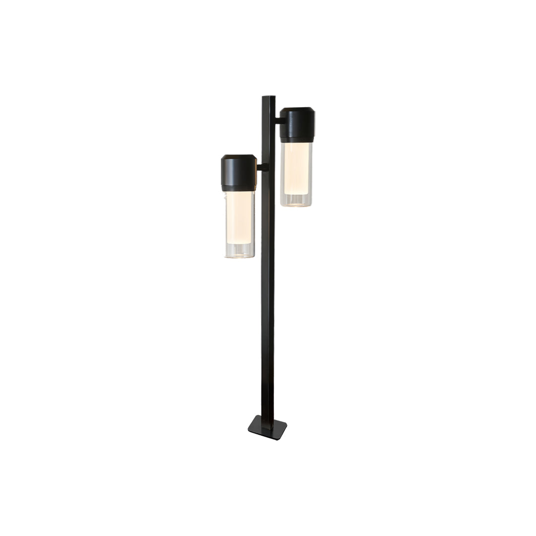 Black contemporary path light with a modern geometric lantern positioned near the top of the pole.