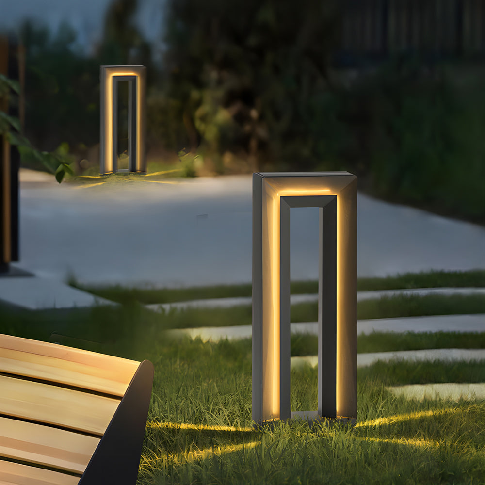 Contemporary LED outdoor path lights with geometric frame design providing elegant landscape lighting for garden pathways