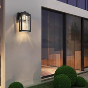Modern outdoor wall sconce with geometric design mounted on contemporary building