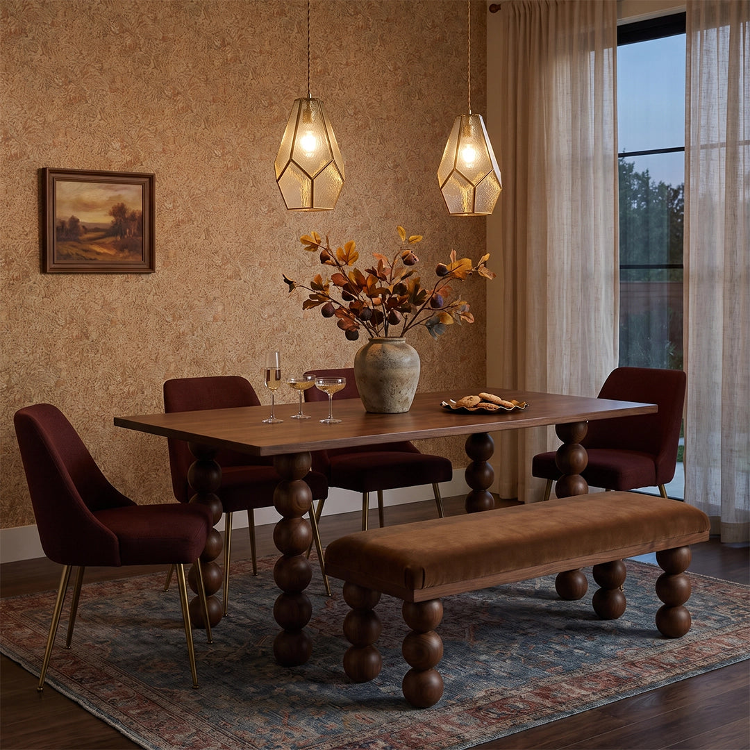 Geometric pendant lights hanging above a wooden dining table in a cozy dining room.