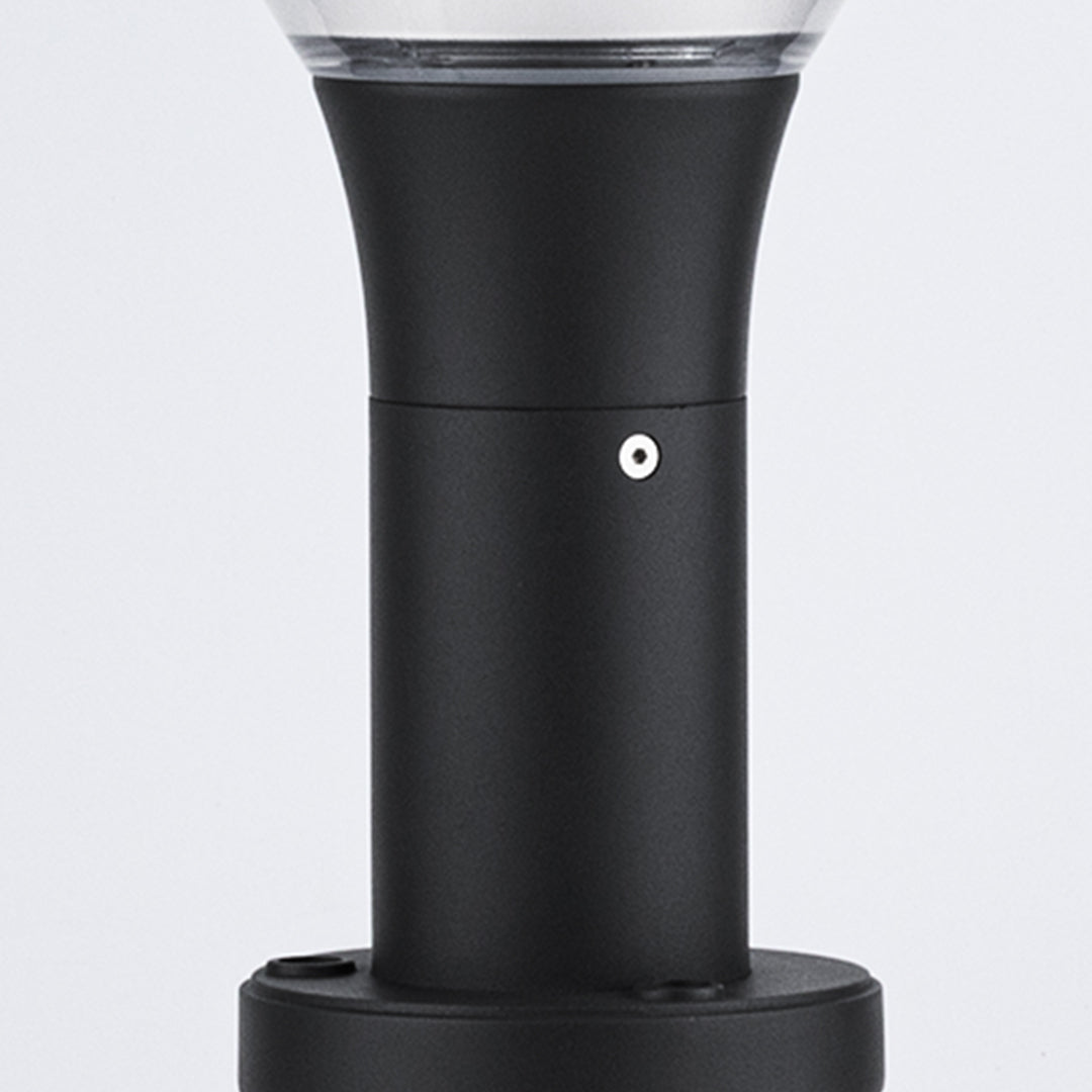 Bollard light providing warm ambient lighting along curved residential walkway