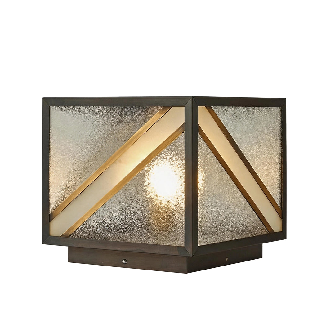 Geometric solar pillar light with black metal housing and diagonal gold accents