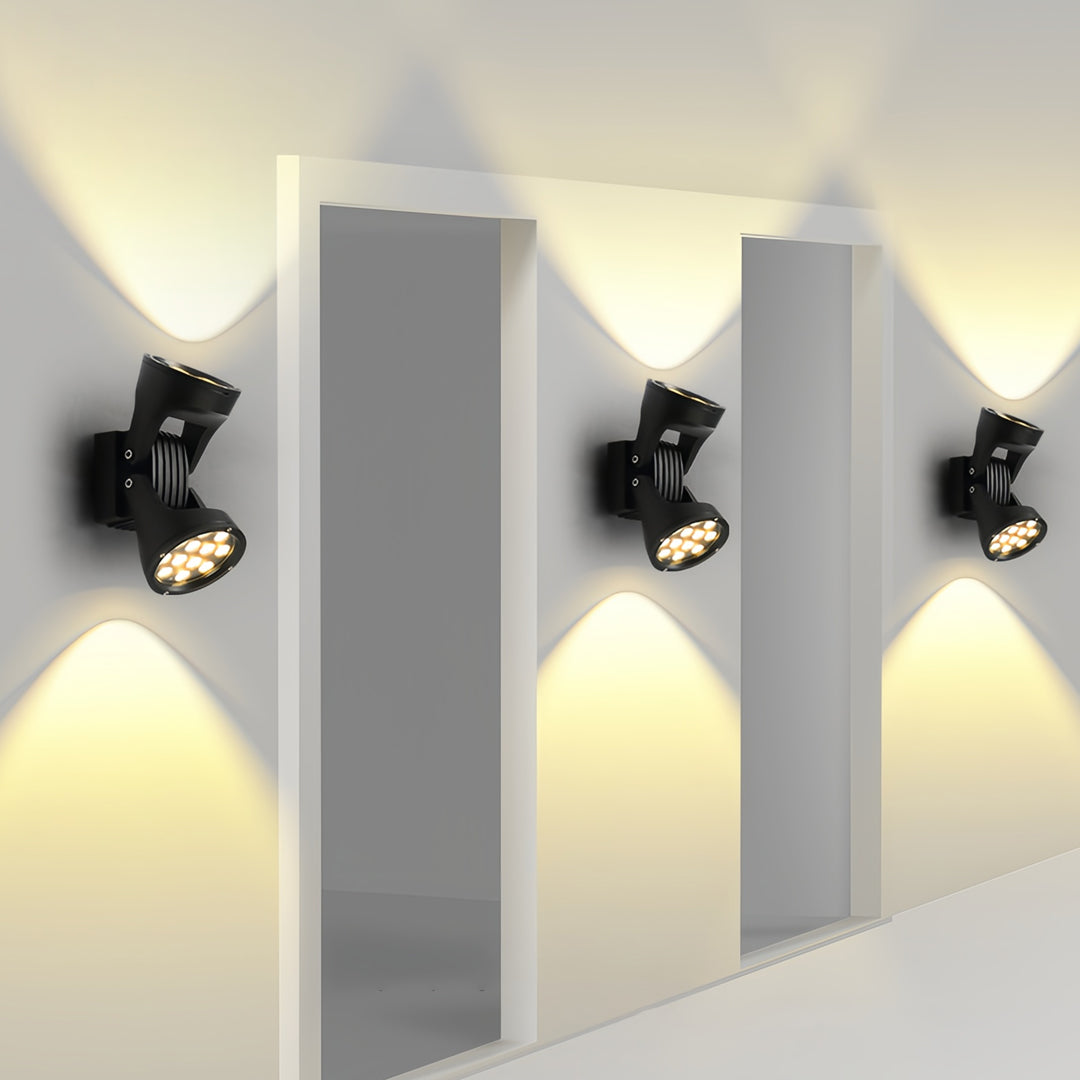 Multiple two light wall sconces creating geometric lighting patterns on a clean architectural facade.