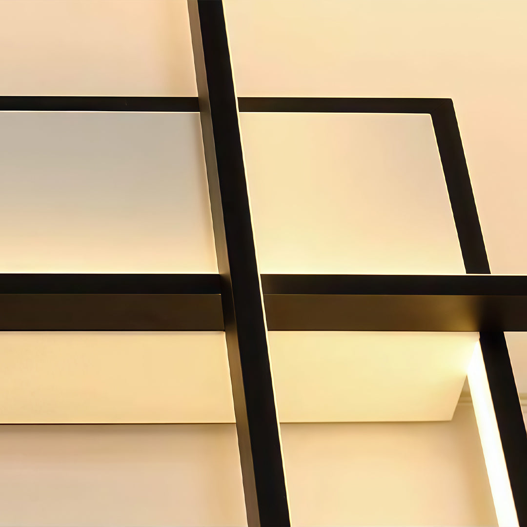 Geometric wall sconce in black and gold, close-up of the overlapping frames.