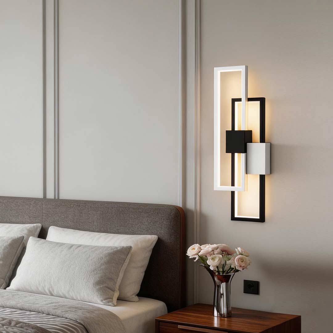 Geometric wall sconce light illuminating a modern bedroom with warm ambient glow.