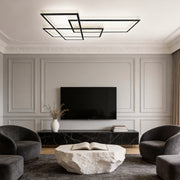 Geometric wall sconce illuminating a modern living room with sleek, ambient glow.