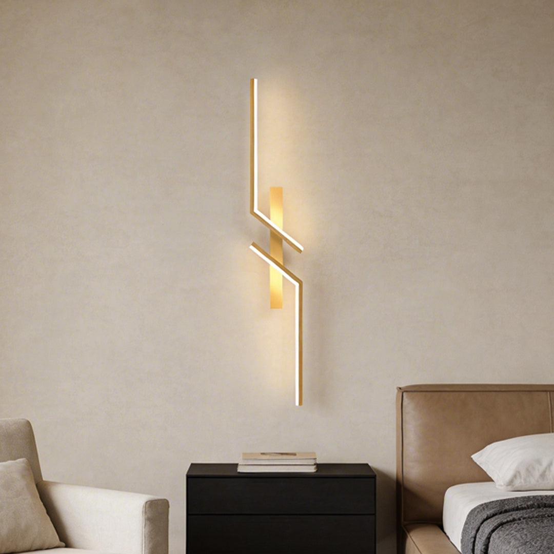 Sleek geometric wall sconce mounted above a sofa, providing warm ambient lighting.