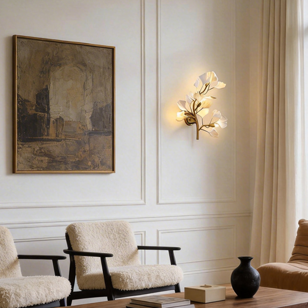 Ginkgo wall light illuminating a modern bedroom with warm ambient glow.