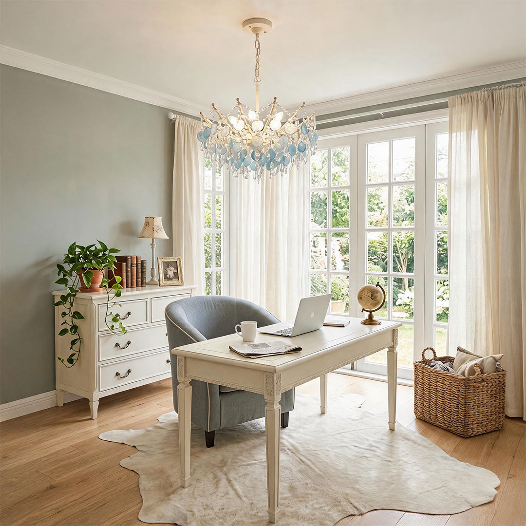 Glam chandelier hanging above a dining table with elegant blue glass details.