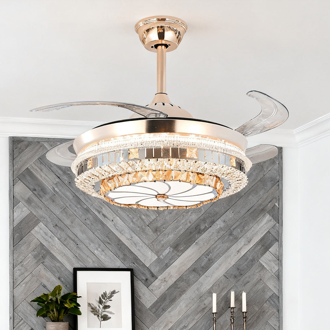 Glamorous gold ceiling fan with light featuring hidden blades against chevron wood paneling 