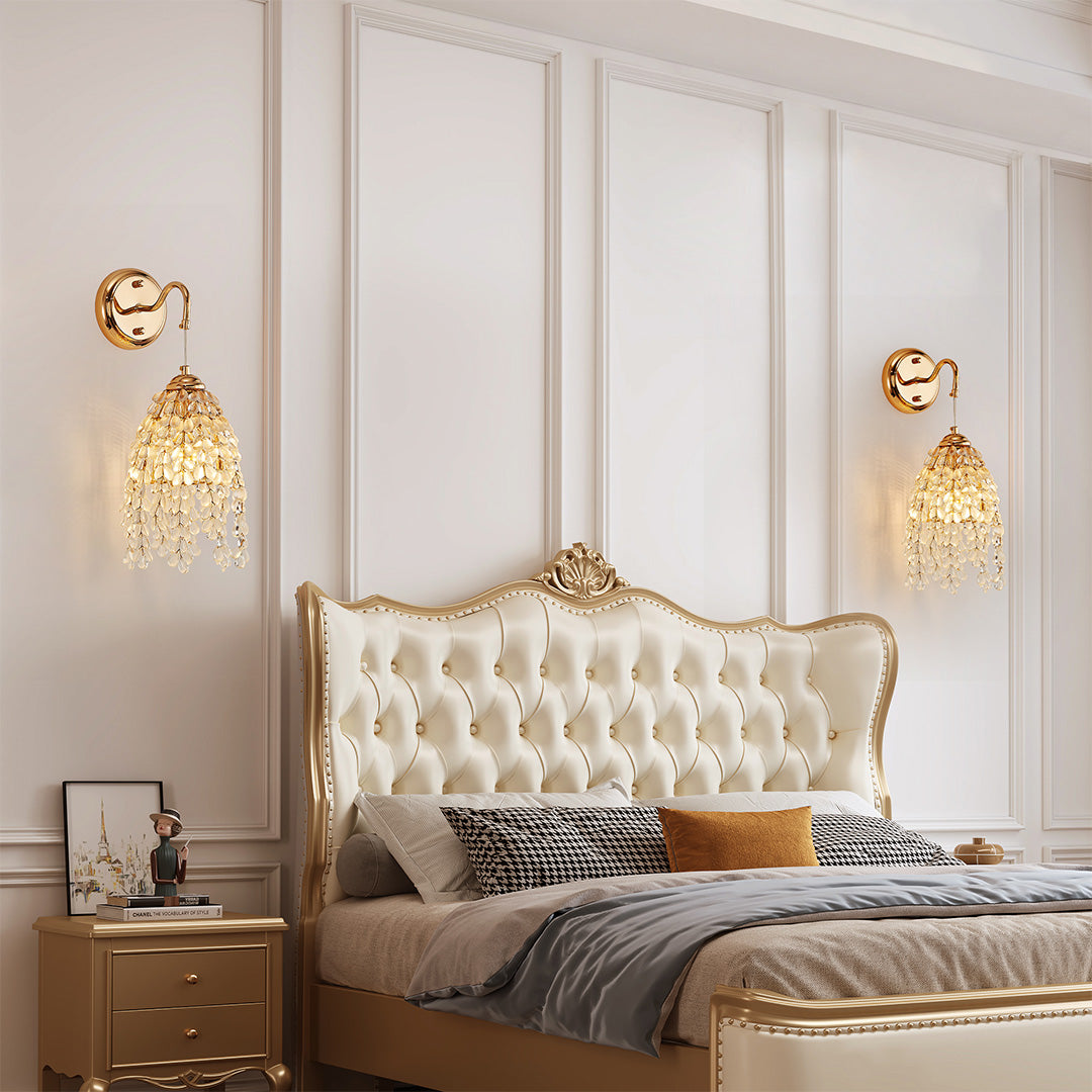 Glamorous LED wall light decor with glass shade chandelier styling illuminating elegant bedroom with tufted headboard and gold accents.