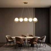 Elegant glass ball linear chandelier with golden accents, illuminating dining and living spaces with a modern touch.
