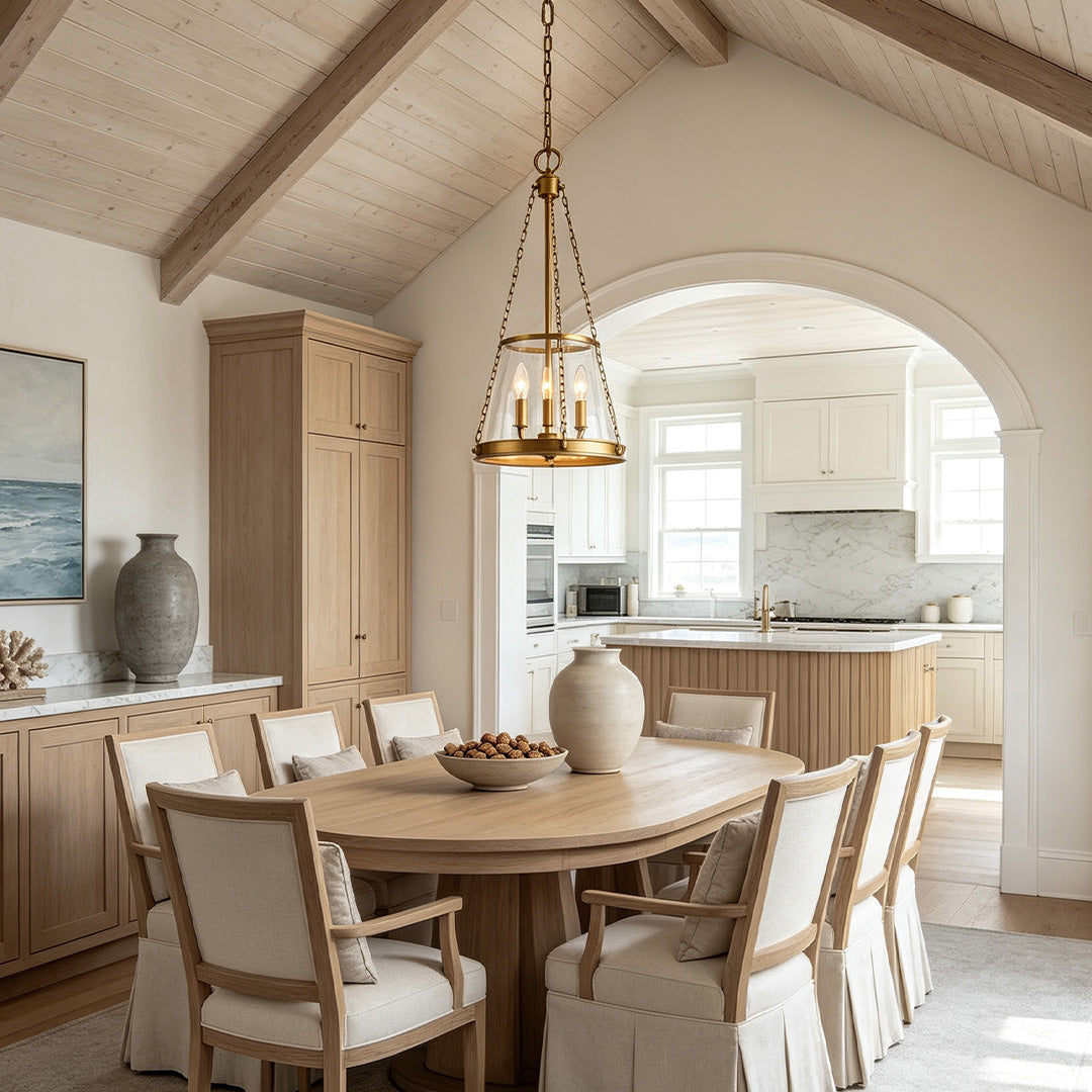 Glass candle chandelier hanging above a rustic dining table in a warm modern farmhouse interior.