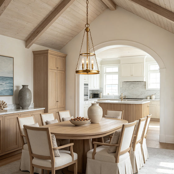 Glass candle chandelier hanging above a rustic dining table in a warm modern farmhouse interior.