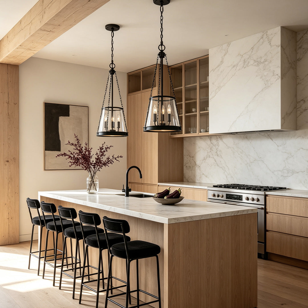 Glass candle chandelier installed above a kitchen island with elegant black metal accents.