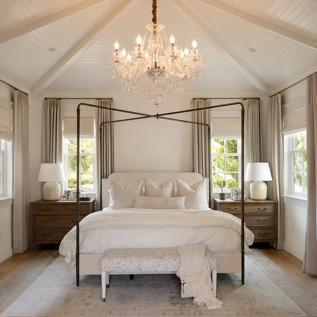 Glass candlelight chandelier hanging above a canopy bed in a bright bedroom with a vaulted ceiling.