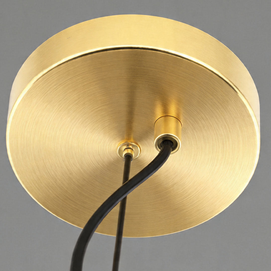 Close-up of brass ceiling mount for glass ceiling light fixture.