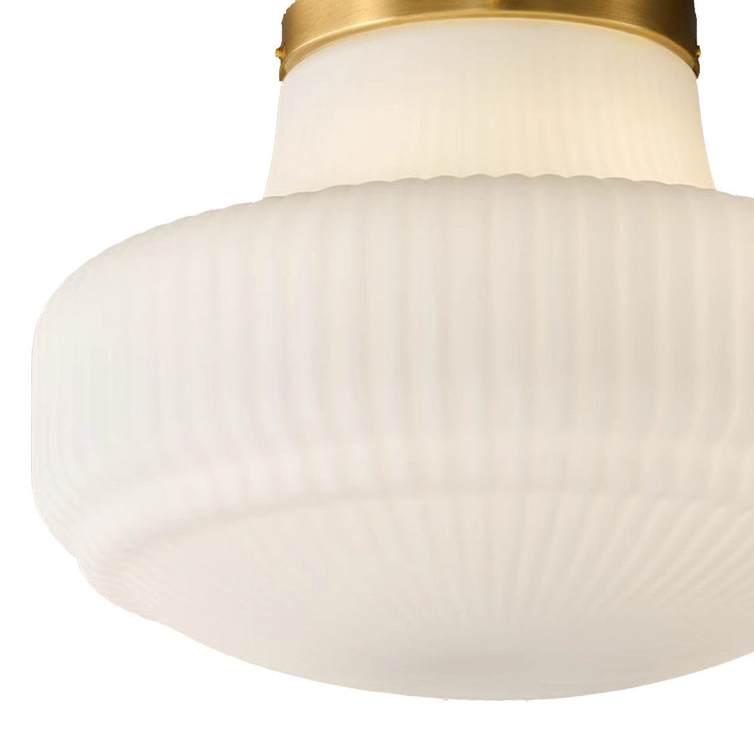 Glass ceiling light fixtures close-up showing ribbed white glass shade and brass trim detail.