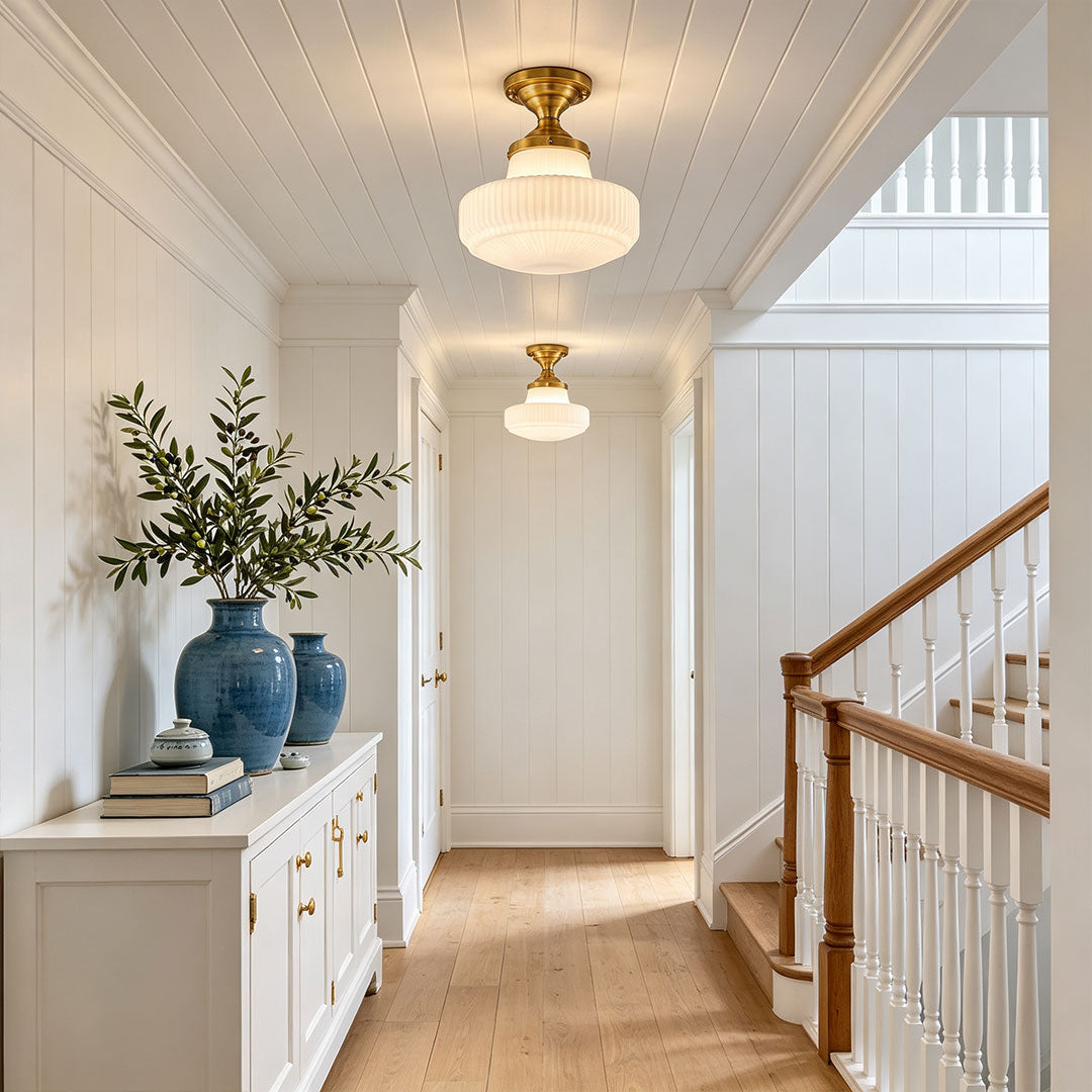 Glass ceiling light fixtures installed in a bright hallway with classic transitional interior styling.