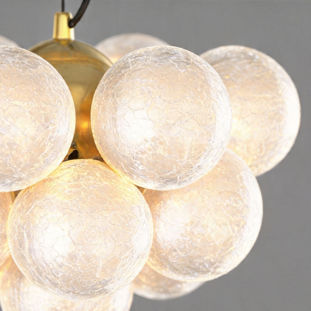 Close-up of textured glass globes in ceiling light fixture with warm glow.