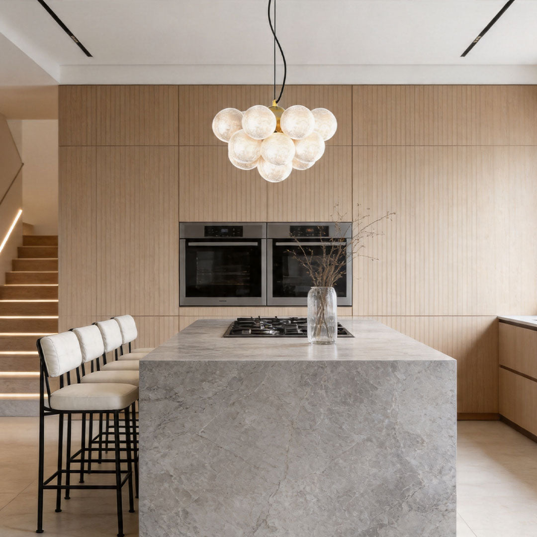 Glass ceiling light fixture above kitchen island with modern minimalist design.