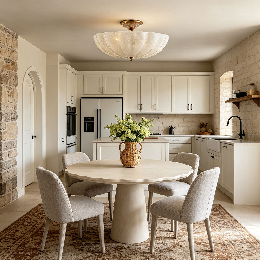 Glass ceiling lights featured above a dining table in a bright modern kitchen interior.