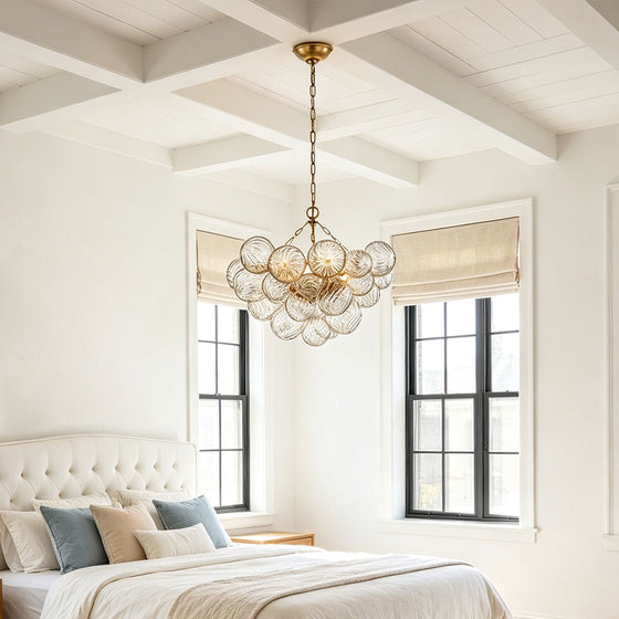 Glass chandelier art installed in a bright bedroom with elegant sculptural lighting design.