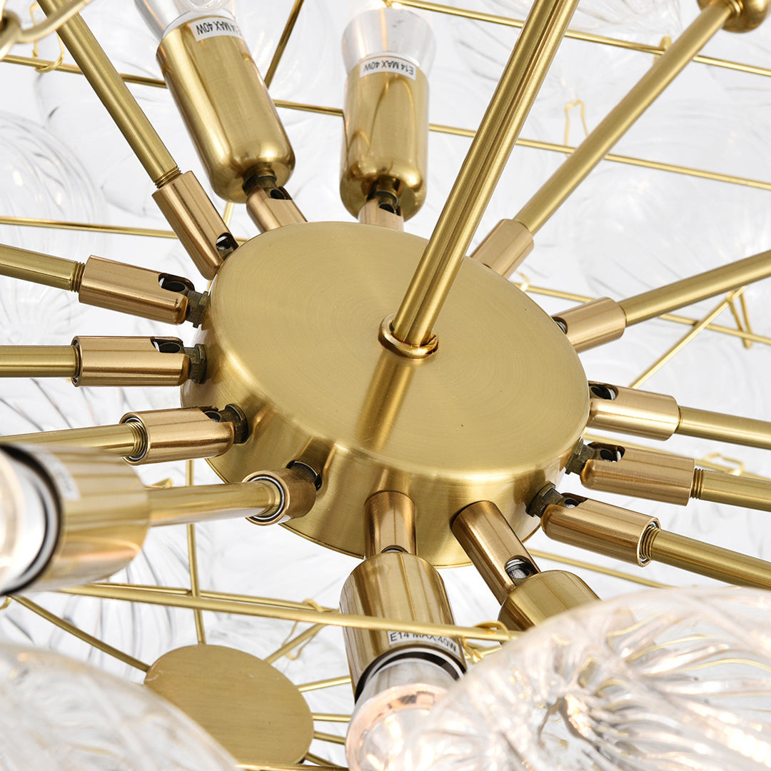 Glass chandelier art detail image featuring brass frame structure and exposed bulb arrangement.