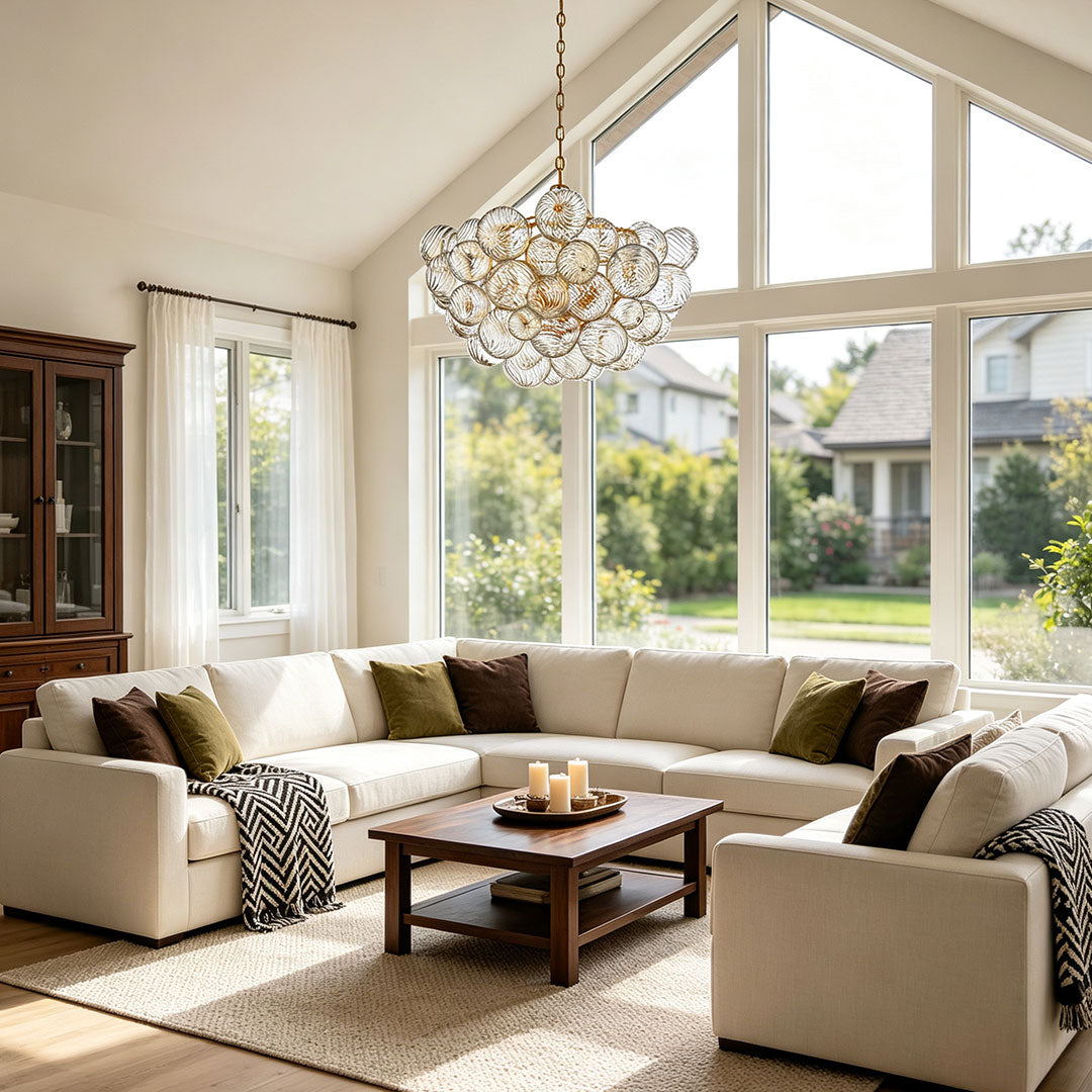 Glass chandelier art featured in a contemporary living room with large windows and soft natural light.